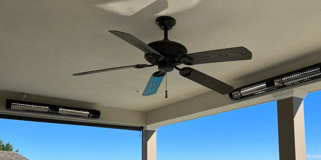 Electric heaters mounted on a covered patio
