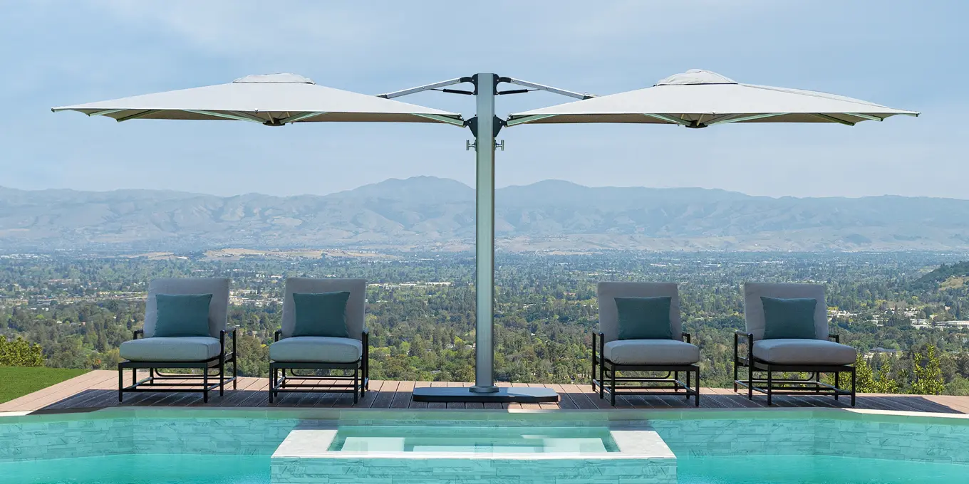 Dual canopy cantilever umbrella shading sunloungers poolside