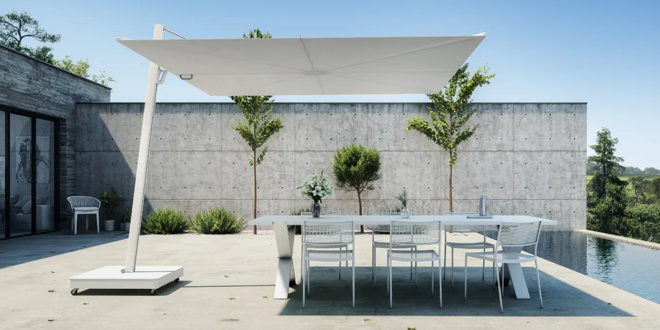 White cantilever umbrella with flat square canopy shading a dining table and chairs